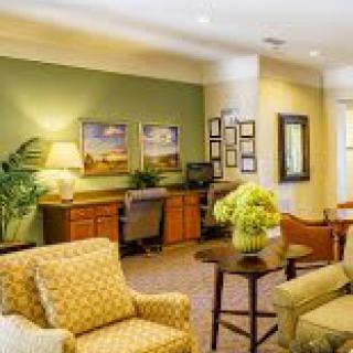 Comfortable living room with seating and workspace area.