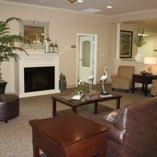 A cozy living room featuring a fireplace and comfortable seating arrangements.