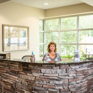 A welcoming reception area with a woman at the front desk.