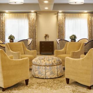 Elegant living room with arranged seating and warm lighting.