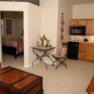 Cozy apartment interior with a kitchenette and bedroom area.