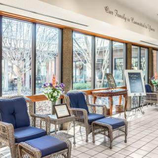 A bright and airy waiting area with comfortable seating and large windows letting in natural light.