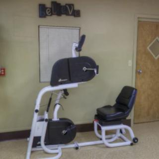Seated exercise machine in a fitness room.