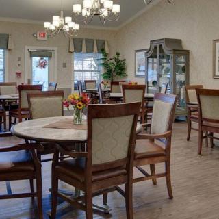 A cozy dining area with elegant furniture and chandeliers.