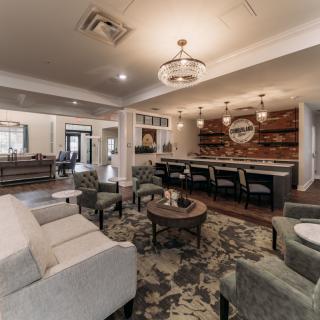 A modern living room with comfortable seating and a stylish bar area.