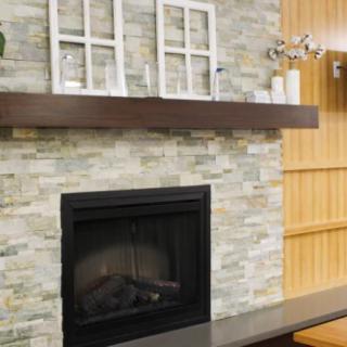 A cozy living room with a brick fireplace and decorative mantel.