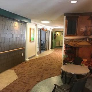 A cozy hallway with carpeted flooring and seating area.