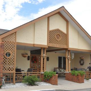 A charming building with a spacious porch and decorative elements.