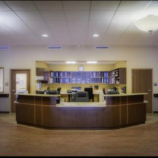 A modern reception area with stylish furniture and warm lighting.