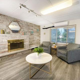 A cozy and modern living room featuring a stylish fireplace and comfortable seating.