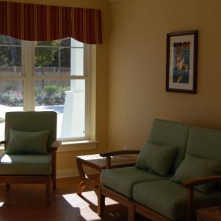 A cozy living room with a sofa and chair set near a window, allowing natural light to fill the space.