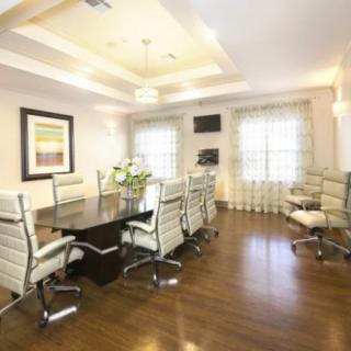 A modern conference room with a large table and stylish chairs.