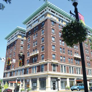 A historic brick building showcasing classic architectural elements in an urban setting.