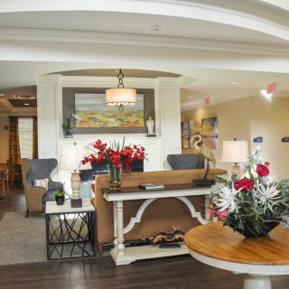 Brightly decorated lobby area with elegant furnishings and floral arrangements.