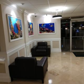 A cozy lobby featuring modern furniture and colorful artwork.