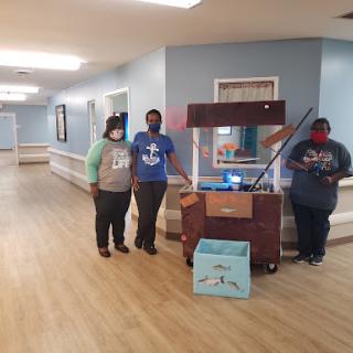 Staff members engage with the community in a welcoming indoor space.