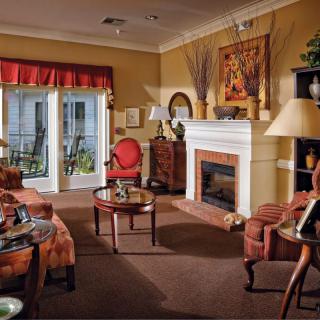 A cozy and traditionally styled living room featuring a fireplace, comfortable seating, and elegant decor.