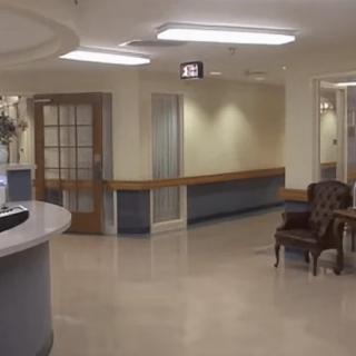 A hospital lobby featuring a reception desk and seating area.