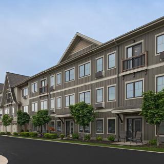 A row of modern townhouses in a suburban area.