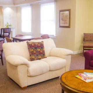A cozy living room with a comfortable sofa, coffee table, and elegant decor.