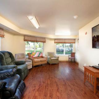 A cozy living room with various seating options and large windows.