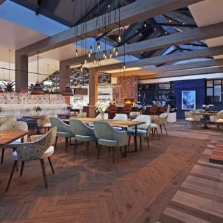 A modern, elegantly designed restaurant interior with contemporary furnishings and an open dining area.