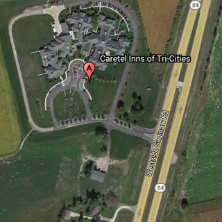 Aerial view of a residential property situated near a major highway.