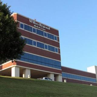 A modern healthcare building with a brick and glass exterior.