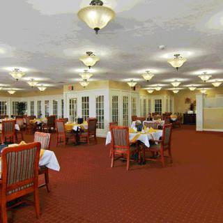 A spacious dining room with neatly arranged tables and elegant lighting.