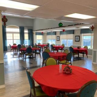 A spacious dining area set up with red tablecloths, ready for an event or gathering.