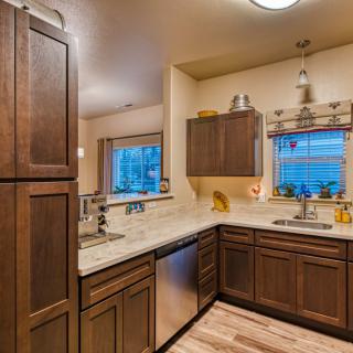 A modern kitchen with dark wooden cabinets and a spacious countertop.