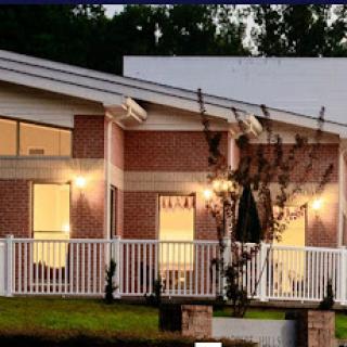 A modern residential building with warm lighting and a welcoming entrance.