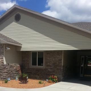 A modern single-story house with a stone facade and well-maintained landscaping.