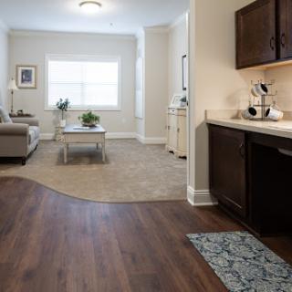 A bright and spacious living area featuring modern furniture and a seamless transition to the kitchen.