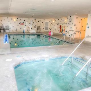 Indoor swimming pool and hot tub facility with a relaxing atmosphere.