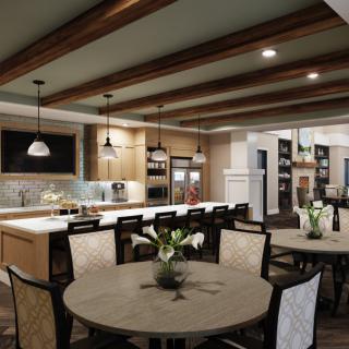 A modern open-concept kitchen and dining area with ceiling beams, pendant lighting, and wooden furniture.