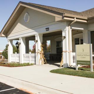 A welcoming entrance to a residential building with well-maintained landscaping.