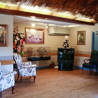 A cozy waiting room with floral chairs and a television.