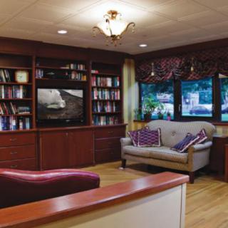 A cozy living room with a large bookshelf and comfortable seating.