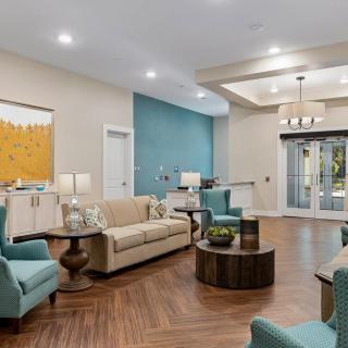 A modern living room with elegant furniture and warm lighting.