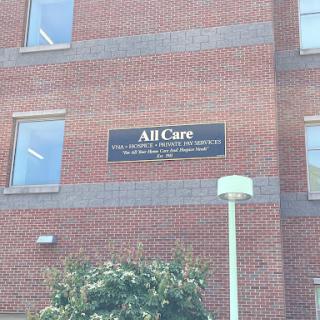 A building displaying a sign that reads 'All Care'.