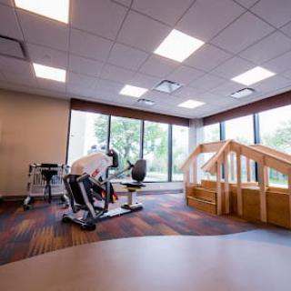 A modern rehabilitation center featuring specialized exercise equipment and therapy stairs for physical therapy sessions.