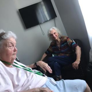 Two elderly women sitting in a living room.