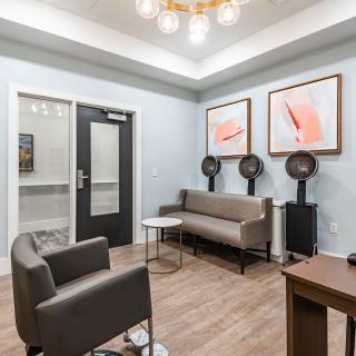 A modern salon waiting area with comfortable seating and stylish decor.