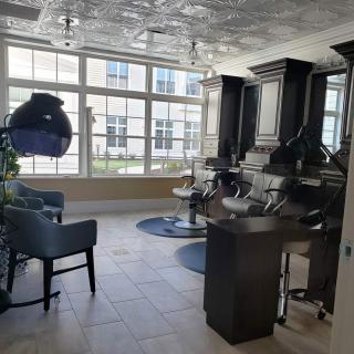 A bright and stylish hair salon with modern equipment and large windows.