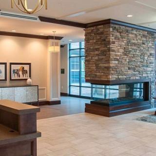 A modern lobby with a stone fireplace and reception area.