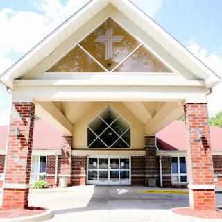 A welcoming church entrance featuring a prominent cross.