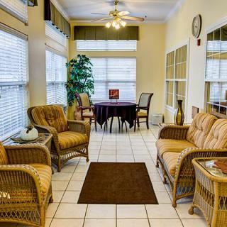 A cozy living room with wicker furniture and ample natural light.