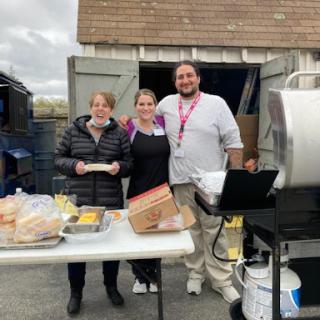 Volunteers gather to serve food at a community event.