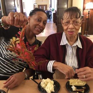 Two people enjoying a meal together indoors.